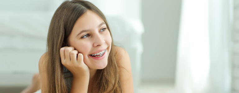 Teenage girl with braces smiling