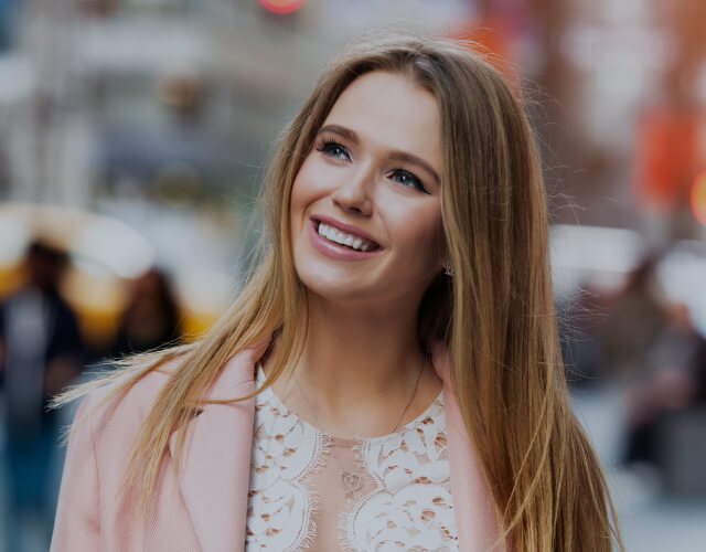 Young woman smiling as she looks into the distance