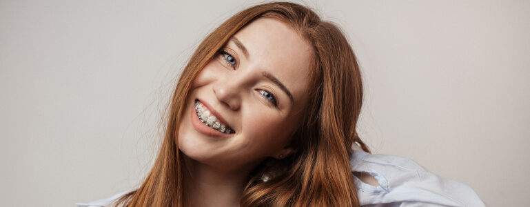 Teenage girl with braces smiling